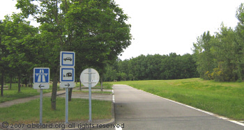 Part of the parking area, with  the wide green spaces beyond.