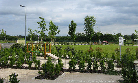 A young but classic French garden, with childrens play areas beyond.