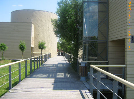 Decking walk, with museum and exhibition buildings to left and right.