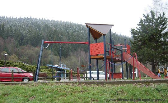 the 
            play area, with snow-topped wooded 'mountains' behind