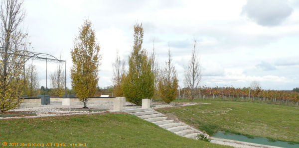 Formal garden with vines beyond, during the autumn