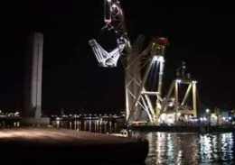 Raising one of the 'butterfly' heads onto its supporting pylon.