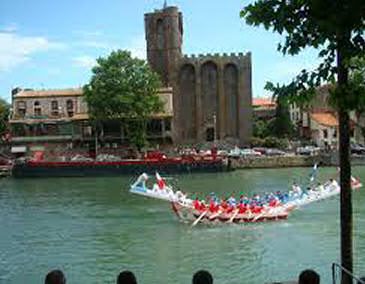 Agde cathedral from the south, with joasting boat