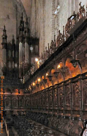 Part of the choir and its stalls, with the organ behind
