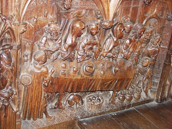 Feast of Cana carving on the side of a choir stall.