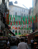 Bayonne pedestrianised shopping street, with banners in Basque colours (red and green)