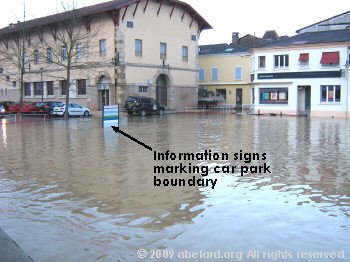 A town car park next to the flooded River Midouze
